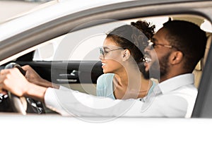 Young black couple in car on road trip, travelling together