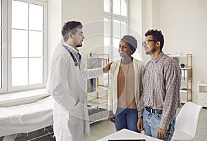 Young black couple planning pregnancy and meeting with family doctor for health checkup