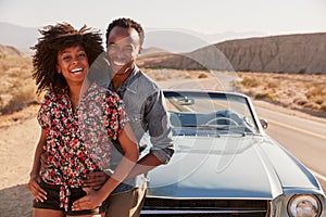 Young black couple on road trip having a roadside stop off