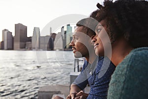 Young black couple standing on quayside, close up