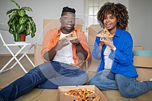 Young Black Couple Taking A Lunch Break With Pizza On Moving Day