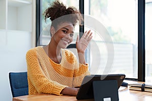 Young black curly hair american african woman using digital tablet