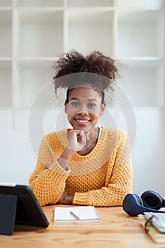 Young black curly hair american african woman using digital tablet