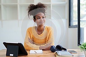 Young black curly hair american african woman using digital tablet