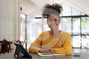 Young black curly hair American African woman using digital tablet