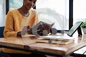 Young black curly hair American African woman using digital tablet