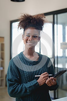 Young black curly hair American African woman using digital tablet