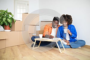Young Black Family Couple Planning Shopping For New Home, Making Checklist