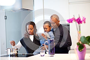 Young black family in fresh modern kitchen