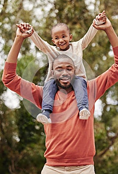 A young black father playing with his daughter happy, smiling and bonding while enjoying quality time together. A little