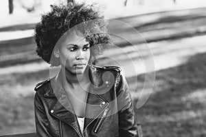 Young black woman with afro hairstyle standing in urban background