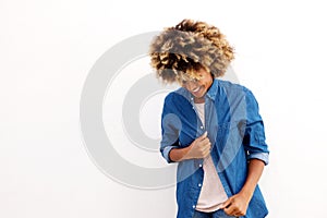 Young black female looking down and smiling on white background