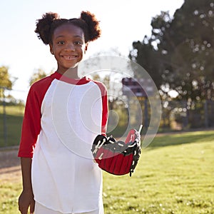 Young Black girl with baseball mitt, smiling, square format