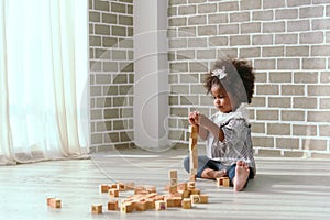 Young black girl is having fun playing and learning to strengthen her cognitive skills at home