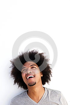 Young black guy with afro laughing and looking up