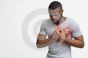 Young black guy having heart attack, holding his chest