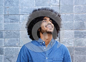 Young black guy laughing and looking up
