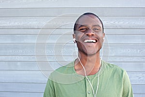 Young black guy smiling with earphones