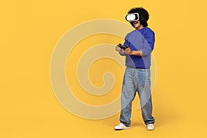 Young black guy wearing VR headset enjoying playing video games