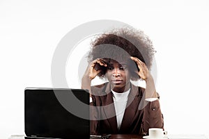 Young black Hispanic business woman, with afro hair, with worried gesture looking at her laptop, in white background