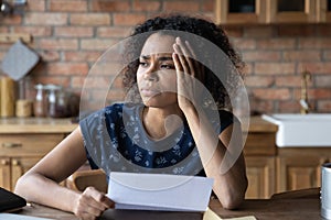 Young black lady hold paper letter think of solving problem