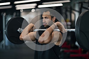 Young Black Male Athlete Working Out With Heavy Barbell At Gym
