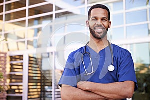 Young black male healthcare worker smiling outside, portrait