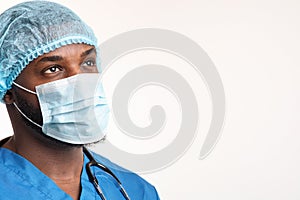 Young black male nurse looking at copy space