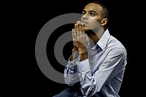 Young black male praying