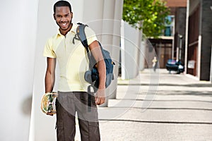 Young Black Male With Skateboard and Bag