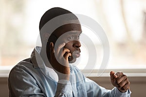 Young black man calling to support call center, problem solving.