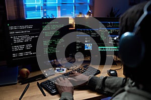 Young Black Man Coding Software on Computer Monitors at Night