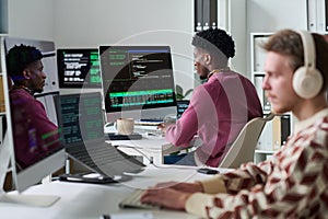 Young Black Man Coding Software at Computer in Office Environment