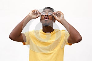 Young black man with glasses looking up