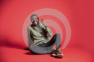 Young Black Man Laughing on Studio Floor