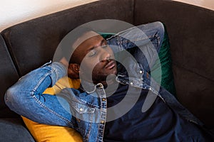 Young Black Man Napping on Couch