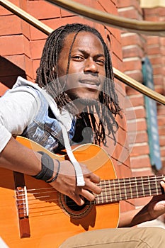 Young black man playing guitar