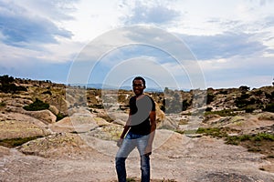 Young black man posing in front of Frig ruins
