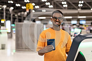 Young black man ready to travel at airport terminal waiting for flight