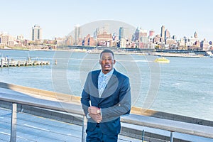 Young black man standing outdoors in New York City, looking forward