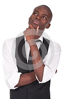 Young black man standing and thinking