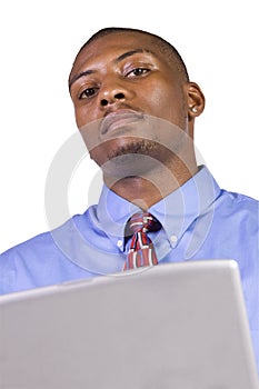 Young black man standing and working on laptop