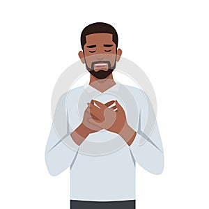 Young black man touched positive. Holds his hands on his chest, expressing gratitude photo