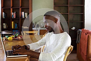 Young black man using laptop computer