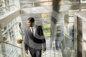 Young black man walking in office