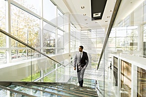 Young black man walking in office