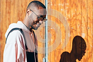 Young black man wearing casual clothes and sunglasses outdoors