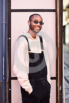 Young black man wearing casual clothes and sunglasses outdoors