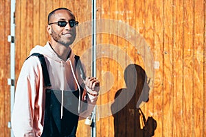 Young black man wearing casual clothes and sunglasses outdoors