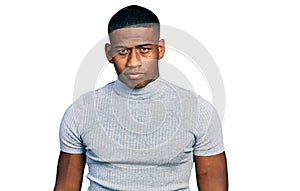 Young black man wearing casual t shirt relaxed with serious expression on face